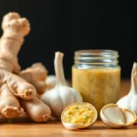 High-quality ginger garlic paste with fresh ginger and garlic bulbs on a rustic wooden surface,